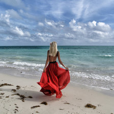 девушка в красной юбке у моря